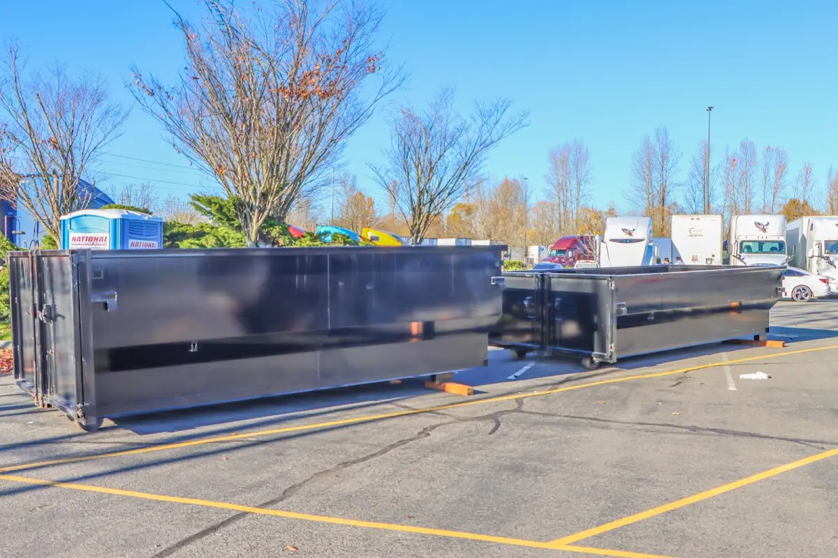 Professional dumpster rental service with roll-off container on residential driveway in Fate